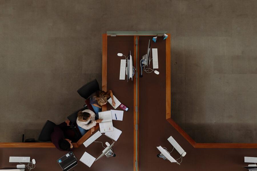 Bird's eye view of students studying in the library.